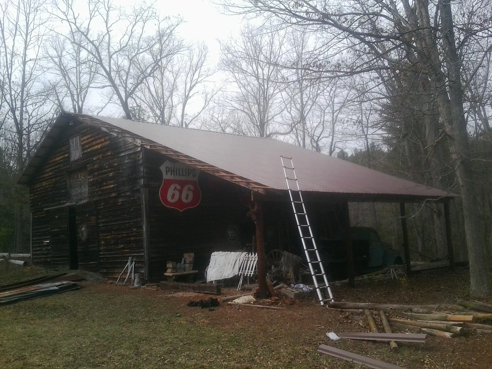 New metal roof on an open sided timber barn with a vintage sign in Williamstown