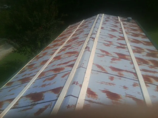 Rusted metal roof panels with new wood purlins before replacement — Storm Damage Roof Repair in Williamstown by Roofing Brothers